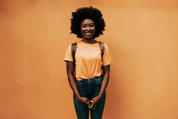 Young smiling attractive african hipster woman standing in outdoors.