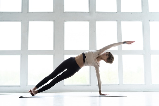 Young smiling attractive woman practicing yoga