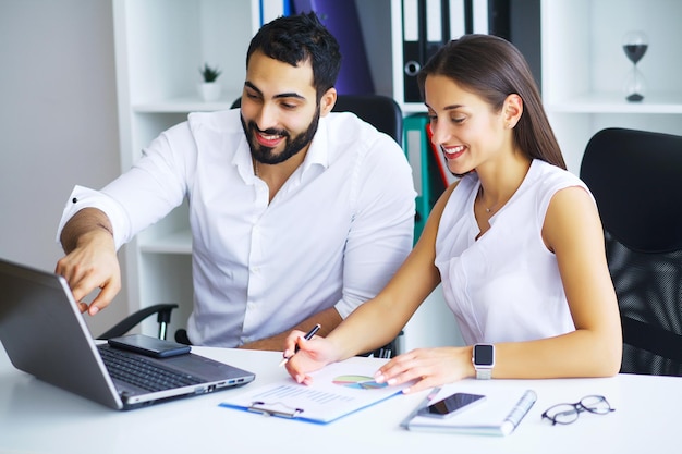 Young smiling business woman and business man