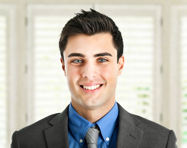 Young smiling businessman in his office