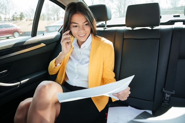 Young smiling businesswoman talking on the phone