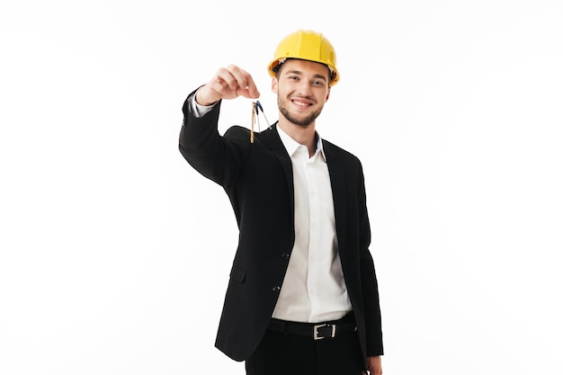 Young smiling bussinesman in yellow safety helmet happily 