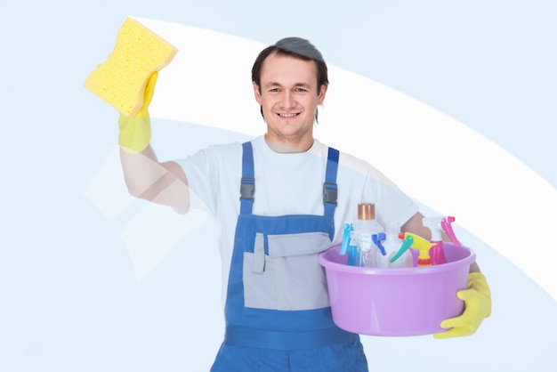 Young smiling cleaner man is cleaning windows.