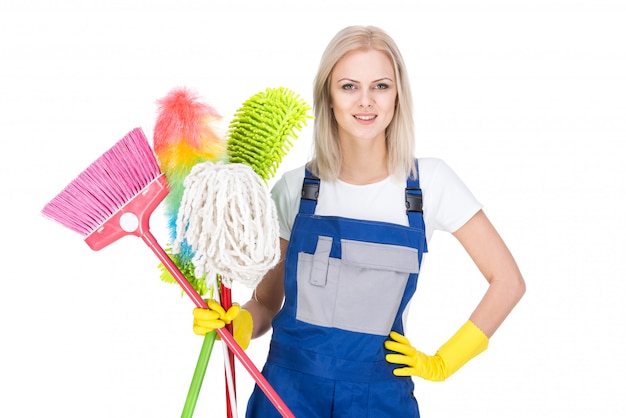 Young smiling cleaner woman with a broom.