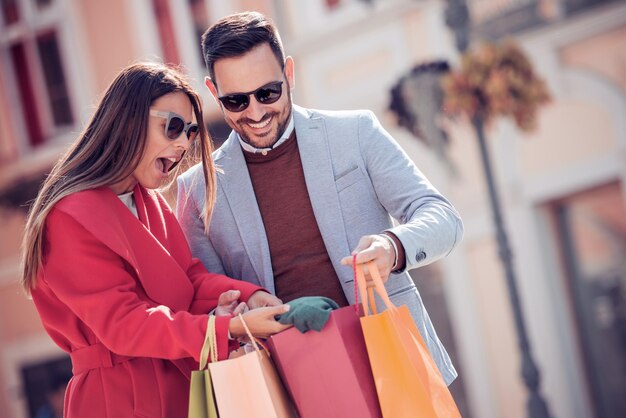 Young smiling couple shopping in the city