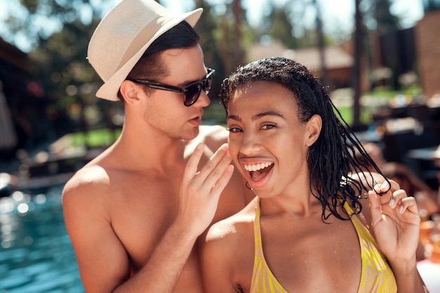 Young Smiling Couple Talking at Pool Party