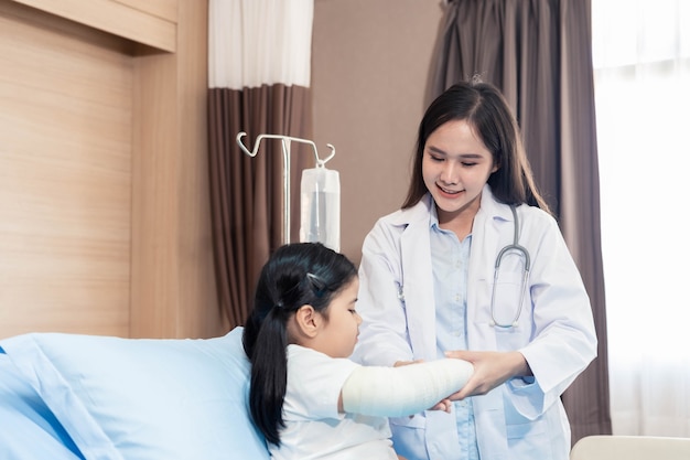 Young smiling female pediatrician doctor and child patient