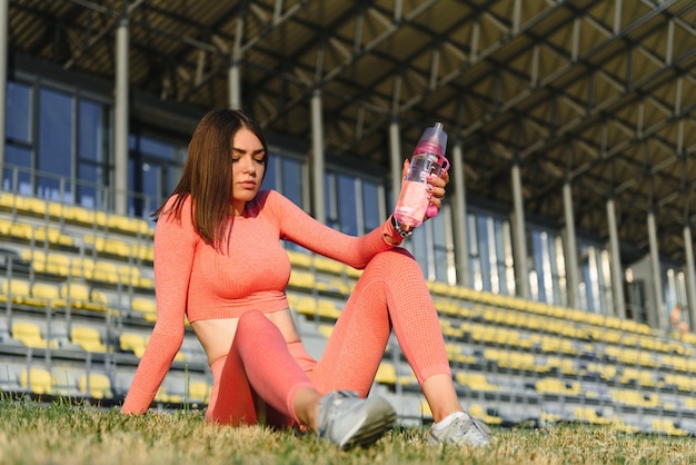 Young smiling female resting after an active fitness training.