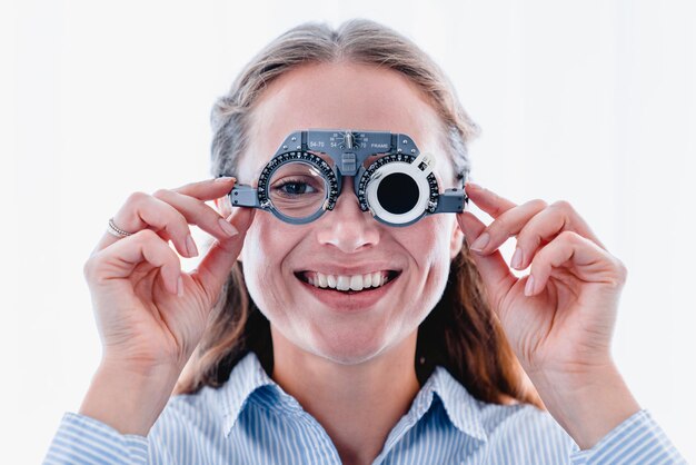 Young smiling girl is fitting special ophthalmic glasses to\
check up her