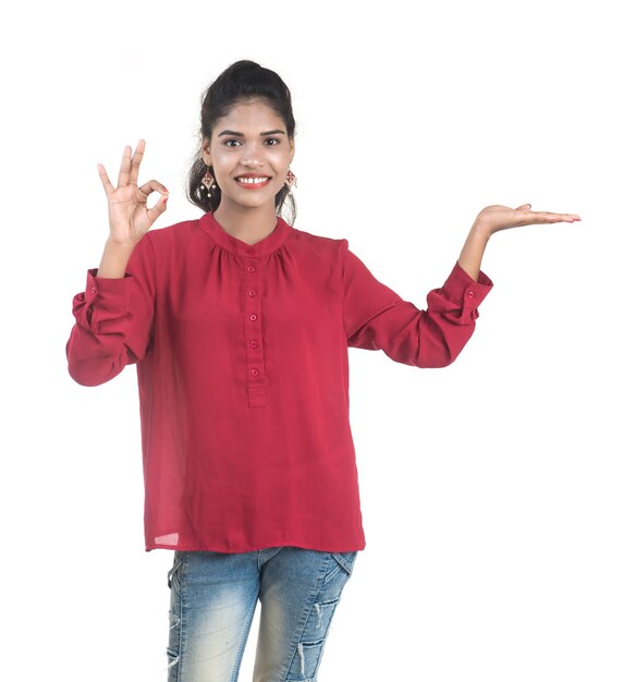 Young smiling girl showing something on 
hand