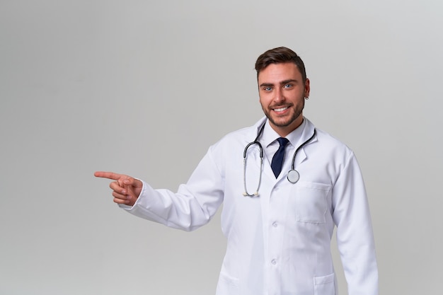 Young smiling handsome caucasian doctor on white background