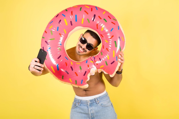 Young smiling happy tourist man hold inflatable ring