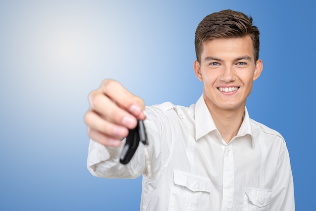 Young smiling man holding car keys