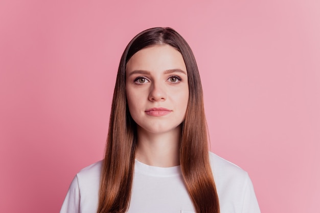 Young smiling readhead girl look at camera on pink background