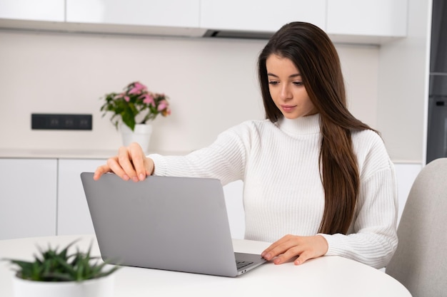 Young smiling student freelancer using a computer for remote work or elearning at the university