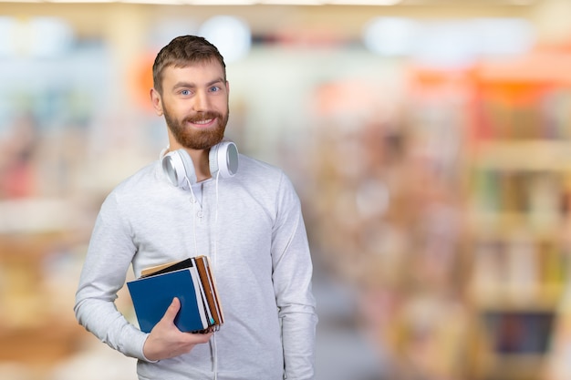 Young smiling student with books