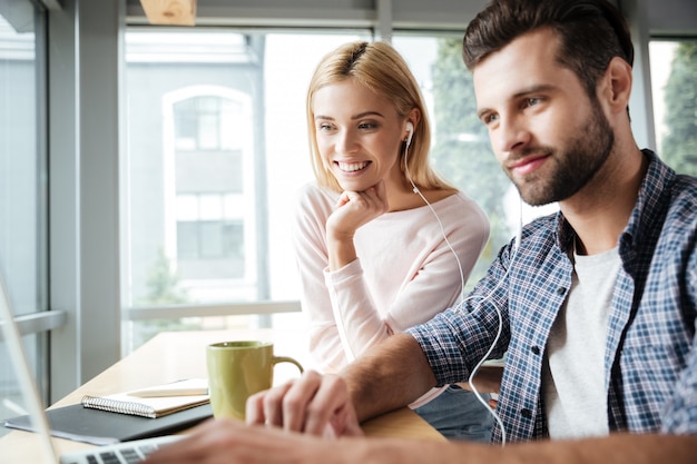 Young smiling two colleagues in office coworking