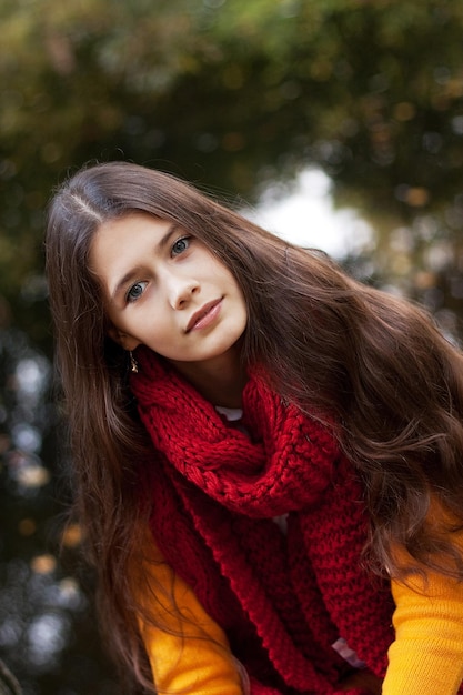 Young smiling woman in autumn park