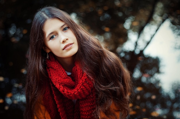 Young smiling woman in autumn park