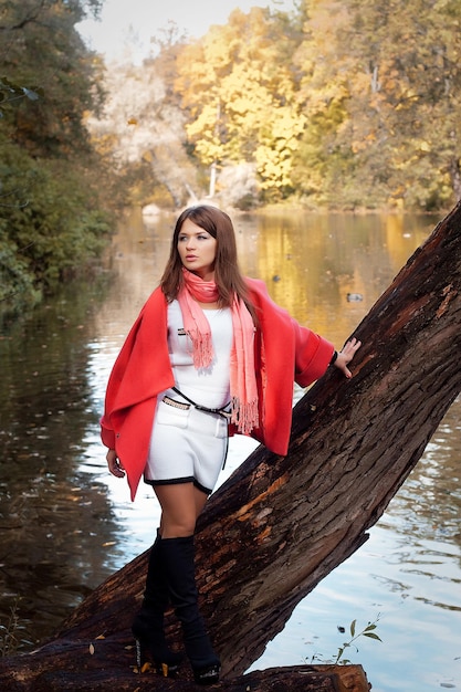 Young smiling woman in autumn park