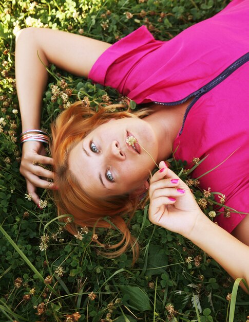 Young smiling woman on the grass 