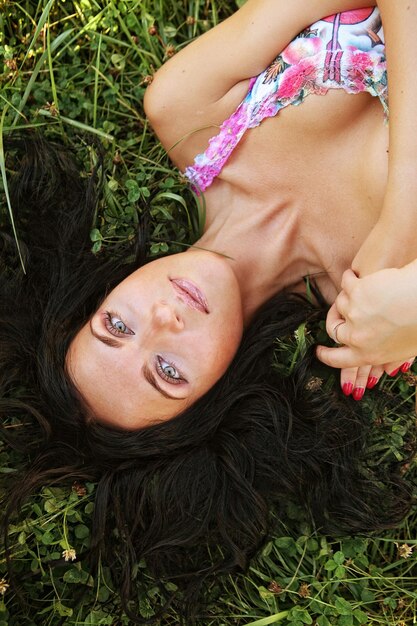 Молодая усмехаясь женщина на траве