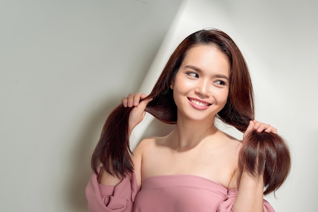 Young smiling woman outdoors portrait. Soft sunny colors.Close portrait. beautiful smiling girl. Woman in the city in summertime. Summer outdoor portrait