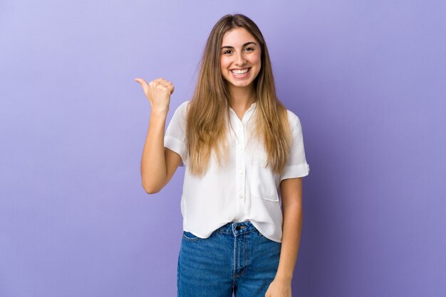 Young smiling woman pointing to the side