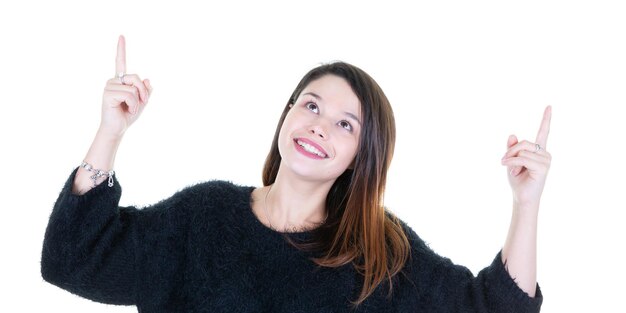 Young smiling woman pointing up looking up