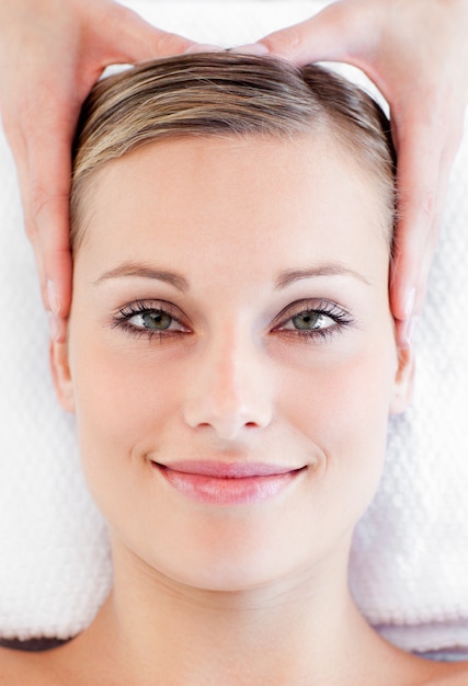 Young smiling woman receiving a head massage