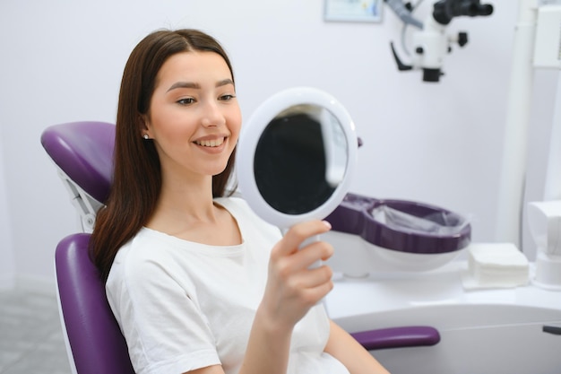 Young smiling woman with beautifiul teeth having a dental inspection