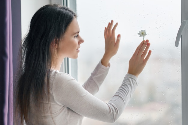 Young smiling woman with chamomile