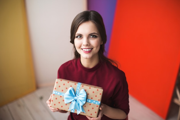 Young smiling woman with gift