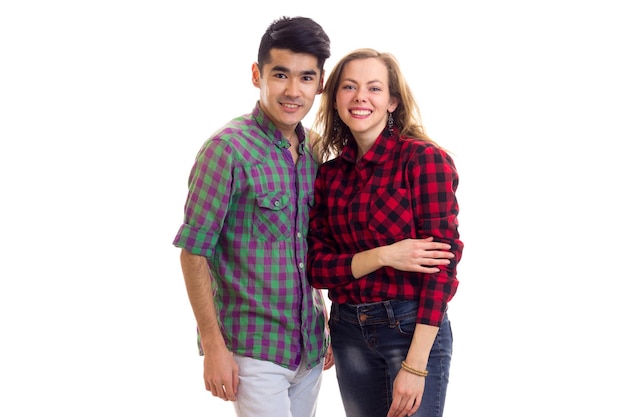 Young smiling woman with long chestnut hair and young handsome man with dark hair in plaid shirts