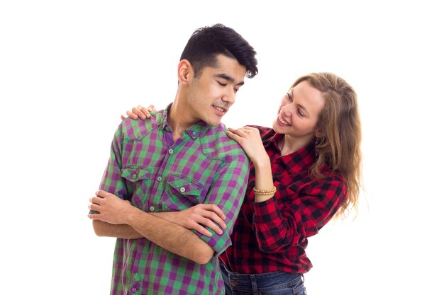 Young smiling woman with long chestnut hair and young pleasant man with dark hair in plaid shirts