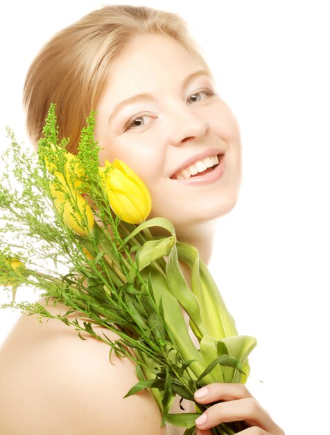 Young smiling woman with yellow tulips