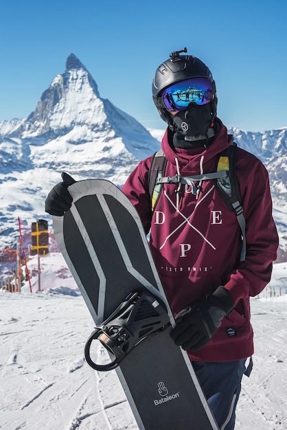 Young snowboarder spending winter holidays in zermatt near the famous matterhorn peak