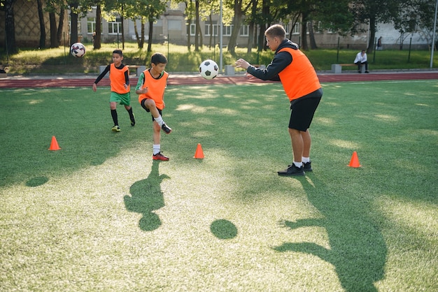 Young soccer coach instructs teen players