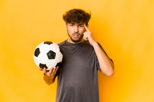 Young soccer player indian man showing a disappointment gesture with forefinger.