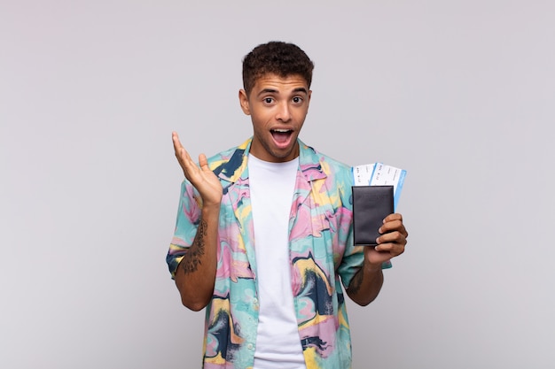 Young south american man feeling happy, surprised and cheerful, smiling with positive attitude, realizing a solution or idea