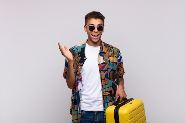 Young south american man feeling happy, surprised and cheerful, smiling with positive attitude, realizing a solution or idea