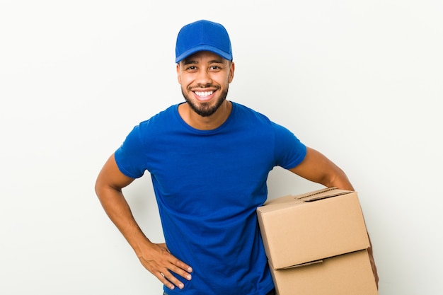 Young south-asian delivery man laughing and having fun