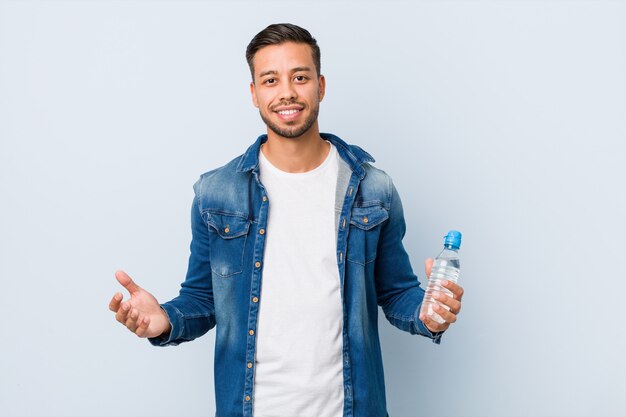 Young south-asian man drinking water