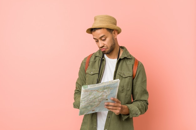 Young south-asian man holding a map