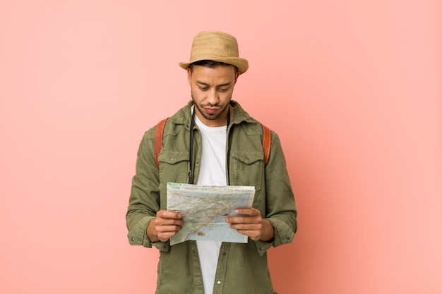 Young south-asian man holding a map