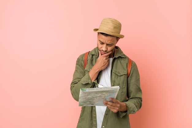 Photo young south-asian man holding a map