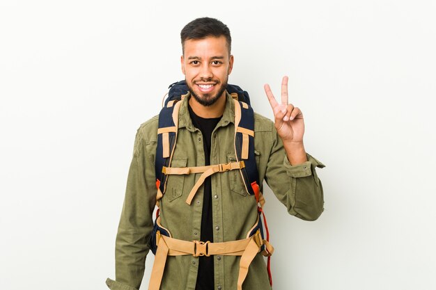 Young south-asian traveller showing number two with fingers.