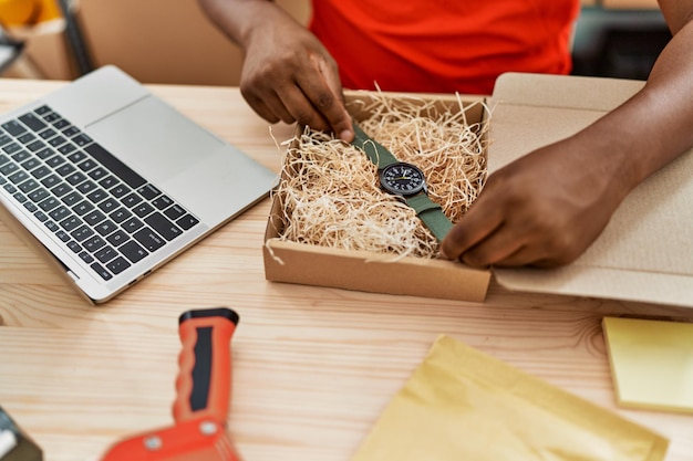 Young south east man preparing watch order at storehouse