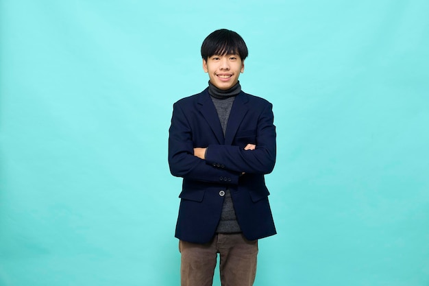 Young Southeast Asian man in light blue studio isolated background