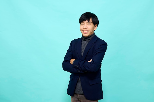 Young Southeast Asian man in light blue studio isolated background